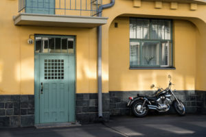 Helsinki, Art Nouveau architecture in Eira district, Juvilakatu, front door, motorcycle