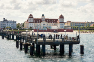 Baltic Sea, seaside resort Binz, spa house and pier with steamer landing, tourists waiting Baltic Sea, seaside resort Binz, spa house and pier with steamer landing, tourists waiting