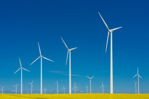 Wind turbines in front of blue sky, symbol image. Wind power, renewable energy Wind turbines in front of blue sky, symbol image. Wind power, renewable energy