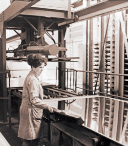 Young woman at work in a cardboard packaging plant from the GDR period around 1968 Young woman at work in a cardboard packaging plant from the GDR period around 1968