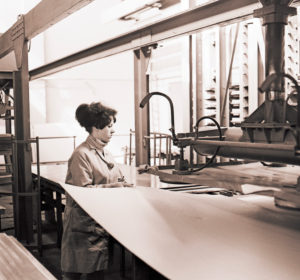 Young woman at work in a cardboard packaging plant from the GDR period around 1968 Young woman at work in a cardboard packaging plant from the GDR period around 1968