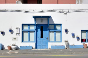Spain, Fuerteventura, El Cotillo, house, number 15, facade, wall, blue door and window Spain, Fuerteventura, El Cotillo, house, number 15, facade, wall, blue door and window
