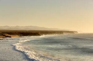 Spain, Fuerteventura, El Cotillo, coast, sea, steep coast, sandy beach, surf, scattered bathers, evening light Spain, Fuerteventura, El Cotillo, coast, sea, steep coast, sandy beach, surf, scattered bathers, evening light