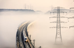 Train, bridge, high-voltage poles, fog Train, bridge, high-voltage poles, fog