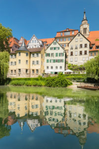 Tuebingen old town with Hölderlin tower and collegiate church reflected in the Neckar, Tuebingen, Baden-Württemberg, Germany Tuebingen old town with Hölderlin tower and collegiate church reflected in the Neckar, Tuebingen, Baden-Württemberg, Germany