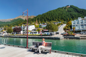 Tourists on the promenade looking towards the skyline, Queenstown Bar and Restaurant, Queenstown, Otago, South Island, New Zealand, Oceania Tourists on the promenade looking towards the skyline, Queenstown Bar and Restaurant, Queenstown, Otago, South Island, New Zealand, Oceania