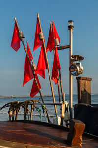 Red pennant on a fishing boat on the beach of Binz, island of Rügen, Mecklenburg-Vorpommern, Germany