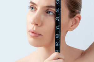 Woman with measuring tape, symbol beauty, pure skin, cosmetic surgery, be perfect Woman with measuring tape, symbol beauty, pure skin, cosmetic surgery, be perfect