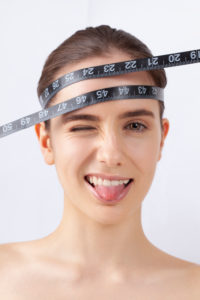 Woman with measuring tape, symbol beauty, pure skin, cosmetic surgery, be perfect Woman with measuring tape, symbol beauty, pure skin, cosmetic surgery, be perfect