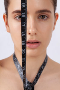 Woman with measuring tape, symbol beauty, pure skin, cosmetic surgery, be perfect Woman with measuring tape, symbol beauty, pure skin, cosmetic surgery, be perfect