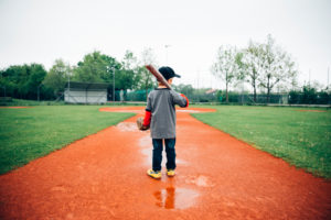 Boy, 5 years old, play baseball on a sports field in the rain, determination, training with ball, racquet and baseball glove, deep colours, focused, centred, Boy, 5 years old, play baseball on a sports field in the rain, determination, training with ball, racquet and baseball glove, deep colours, focused, centred,