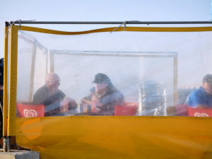 Two fishermen in the evening in a snack bar behind a windbreak in the harbour of Roscoff in Brittany. Two fishermen in the evening in a snack bar behind a windbreak in the harbour of Roscoff in Brittany.