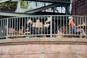 Guests in a garden restaurant on a sunny afternoon at the Eiserner Steg in Frankfurt. Guests in a garden restaurant on a sunny afternoon at the Eiserner Steg in Frankfurt.