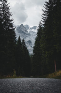 Italy, South Tyrol, road, forest, snowy mountains Italy, South Tyrol, road, forest, snowy mountains