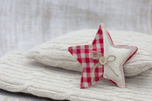 Home-made Christmas jewelry on cushion, still life Home-made Christmas jewelry on cushion, still life