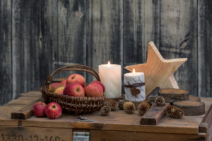 rustic still life hygge style with wooden stars, apples and candles on old crate rustic still life hygge style with wooden stars, apples and candles on old crate