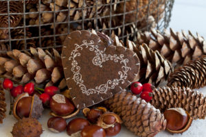 rustic autumn decoration with felt heart and pine cones and chestnuts rustic autumn decoration with felt heart and pine cones and chestnuts