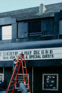 USA, California, Los Angeles, club "The Roxy Theater", employee exchanges event details on neon signs USA, California, Los Angeles, club "The Roxy Theater", employee exchanges event details on neon signs