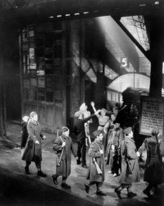 1930s BUSY LEXINGTON AVENUE TRAFFIC AND BLOOMINGDALES STORE WITH FLAGS  PEDESTRIAN SHOPPERS AT 59TH STREET NEW YORK CITY USA - SuperStock