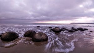 Moeraki Boulders, round stones on the beach of New Zealand Moeraki Boulders, round stones on the beach of New Zealand