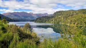Lake surrounded by forest and mountain in the background in Argentina Lake surrounded by forest and mountain in the background in Argentina