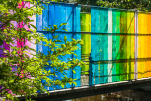 Sweden, Narke, Orebro, Slottsparken park, park bridge draped with rainbow-colored plastic Sweden, Narke, Orebro, Slottsparken park, park bridge draped with rainbow-colored plastic