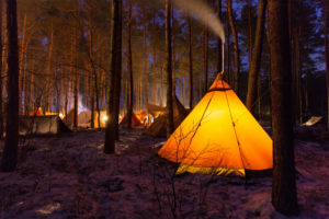 Tepee in the forest illuminated at night Tepee in the forest illuminated at night