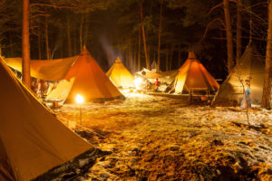 Tipi camp lit in the forest at night Tipi camp lit in the forest at night