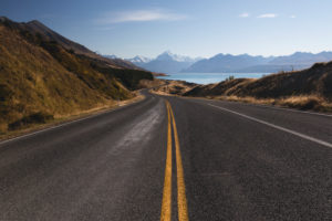 Median strip on the road points the way to Mt Cook in the distance, Lake Pukaki, Canterbury, New Zealand Median strip on the road points the way to Mt Cook in the distance, Lake Pukaki, Canterbury, New Zealand
