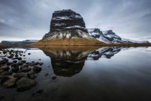 Slightly snowy mountains near Kálfafell with reflection, Suðurland, Iceland Slightly snowy mountains near Kálfafell with reflection, Suðurland, Iceland