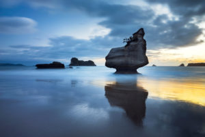 Rock formation on the beach at Mare's Leg Cove at sunrise, Coromandel Peninsula, New Zealand Rock formation on the beach at Mare's Leg Cove at sunrise, Coromandel Peninsula, New Zealand