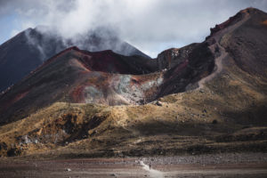 Hikers in Tongariro National Park with large craters in the background, Ruapehu District, New Zealand Hikers in Tongariro National Park with large craters in the background, Ruapehu District, New Zealand