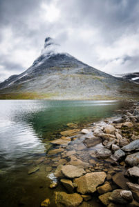 View over lake shore to Kyrkja with fog, Jotunheimen, Norway View over lake shore to Kyrkja with fog, Jotunheimen, Norway