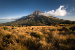 Mount Taranaki with single cloud in warm evening light, Egmont National Park, New Zealand Mount Taranaki with single cloud in warm evening light, Egmont National Park, New Zealand
