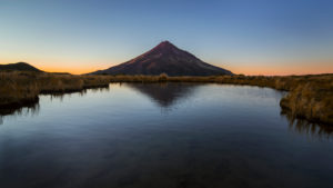 Mount Taranaki at sunrise with reflection, Pouakai Track, Egmont National Park, New Zealand Mount Taranaki at sunrise with reflection, Pouakai Track, Egmont National Park, New Zealand