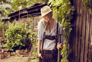 Woman, blond, leather trousers, checked blouse, hat, hayfork, woodsheds, stand, smile happy, half portrait, Woman, blond, leather trousers, checked blouse, hat, hayfork, woodsheds, stand, smile happy, half portrait,