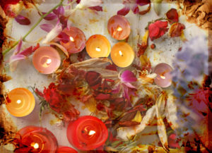 atmospheric table decoration with candles and blossoms in orange, yellow, red, brown and natural tones