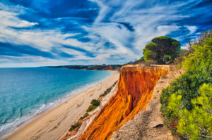 Europe, Portugal, Algarve, Litoral, Barlavento, Faro district, between Vilamoura and Albufeira, Praia da Falesia, cliffs and beach, picturesque formations, made of yellow and reddish brown limestone and sandstone Europe, Portugal, Algarve, Litoral, Barlavento, Faro district, between Vilamoura and Albufeira, Praia da Falesia, cliffs and beach, picturesque formations, made of yellow and reddish brown limestone and sandstone