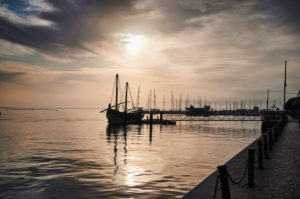 Europe, Portugal, Algarve, Litoral, Sotavento, District Faro, Olhao, promenade at the market halls, historic fishing boat, Atlantic crossing 1808, landmark, silhouette of the Caique Bom Sucesso, at sunset Europe, Portugal, Algarve, Litoral, Sotavento, District Faro, Olhao, promenade at the market halls, historic fishing boat, Atlantic crossing 1808, landmark, silhouette of the Caique Bom Sucesso, at sunset