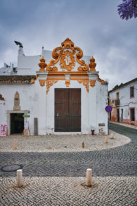 Europe, Portugal, Algarve, Litoral, Barlavento, Felsalgarve, District Faro, Lagos, Praca do Infante Dom Henrique, historical portal of the Armazem Regimental, former regimental camp, built in 1665, baroque decoration with coat of arms of the former Kingdom of Algarve, portrait format Europe, Portugal, Algarve, Litoral, Barlavento, Felsalgarve, District Faro, Lagos, Praca do Infante Dom Henrique, historical portal of the Armazem Regimental, former regimental camp, built in 1665, baroque decoration with coat of arms of the former Kingdom of Algarve, portrait format