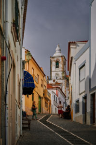 Europe, Portugal, Algarve, Litoral, Barlavento, Felsalgarve, Faro District, Lagos, street scene, alley with a view of the Igreja de Sao Sebastiao church, portrait format Europe, Portugal, Algarve, Litoral, Barlavento, Felsalgarve, Faro District, Lagos, street scene, alley with a view of the Igreja de Sao Sebastiao church, portrait format
