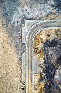 Structures, traces, earth colors, infrastructure, development of a building area, road layout, from above, abstract shapes, portrait format Structures, traces, earth colors, infrastructure, development of a building area, road layout, from above, abstract shapes, portrait format
