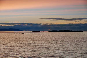 Cruise on the coast of Norway, sunset over the sea, dramatic sky coloring