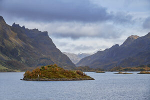 Cruise along the coast of Norway, Lofoten archipelago, small islands at the entrance to Raftsundet, mountain range with dark clouds