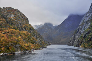 Cruise along the coast of Norway, Lofoten archipelago, narrow channel in the Trollfjord, steep cliffs, exit from the fjord into Raftsundet