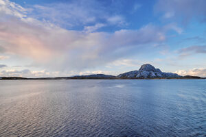 Cruise on the coast of Norway, Vega Archipelago, narrow strip of land on the horizon, rocky hilltop, sky coloring