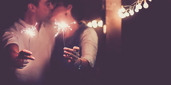 New year and romance couple of caucasian people man and woman kissing celebaring the nightlife party together - concept of couple in love with sparklers for celebrate event 2020 New year and romance couple of caucasian people man and woman kissing celebaring the nightlife party together - concept of couple in love with sparklers for celebrate event 2020