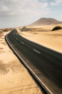 Travel and vehicle long black asphalt road with nature wild outdoor desert around - alternative journey with car and no traffic on highway - climate change or vacation place Travel and vehicle long black asphalt road with nature wild outdoor desert around - alternative journey with car and no traffic on highway - climate change or vacation place
