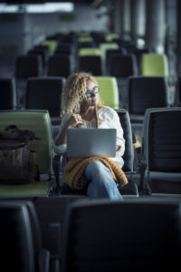 Travel people concept with lonely modern beautiful woman sit down on seats at airport or station waiting to start and enjoy the trip - delay or cancel flights rights - digital nomad work lifestyle Travel people concept with lonely modern beautiful woman sit down on seats at airport or station waiting to start and enjoy the trip - delay or cancel flights rights - digital nomad work lifestyle