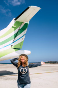 one happy beautiful woman having fun traveling enjoying her vacations outdoors discovering new places - portrait of adult person with airport or aircraft at the background one happy beautiful woman having fun traveling enjoying her vacations outdoors discovering new places - portrait of adult person with airport or aircraft at the background
